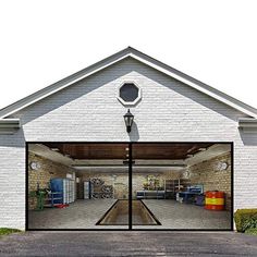 an open garage door on the side of a white brick building with a basketball hoop in it