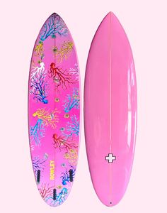 two surfboards are shown side by side on a pink background with corals and seaweed