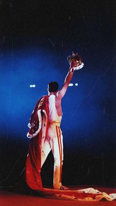 a man holding a baseball glove on top of a stage