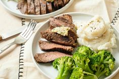 two plates filled with meat, broccoli and mashed potatoes on a table