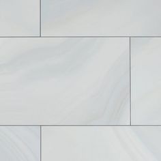 a white tile wall that looks like marble