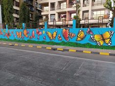 a mural on the side of a building with colorful butterflies painted on it's sides