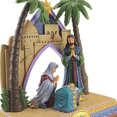 a figurine of the nativity scene with palm trees