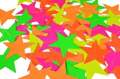 a pile of colorful paper stars on a white background