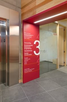 there is a red sign on the wall next to an elevator