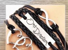 One Direction, Infinity, Double Heart Bracelet Material: alloy, wax attachment, leather Size: The length is 6", the chain extend lenth 1.5" (you can adjust the size if you want) One Direction Accessories, Infinite Bracelet, One Direction Merch, Infinity Charm Bracelet, One Direction Outfits, One Direction Facts, One Direction Niall, Leather Cord Bracelets, Infinity Charm