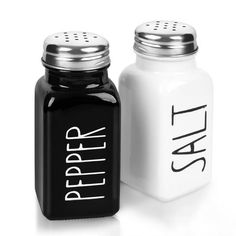 two salt and pepper shakers sitting next to each other