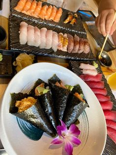 sushi is served on a plate with chopsticks