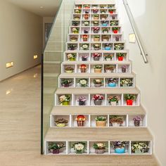 the stairs are decorated with flower pots and flowers in each section, along with glass balconies