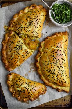 three pieces of bread with sprinkles on them and a bowl of greens