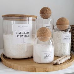 three jars with labels on them are sitting on a shelf next to some spices and salt