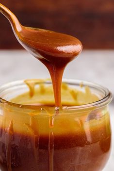 caramel sauce being poured into a glass jar