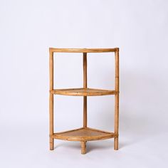 the corner shelf is made out of wood and has two shelves on each side,