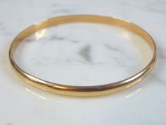 "FOR SALE IS A WOMEN'S VINTAGE ESTATE 17K YELLOW GOLD BRACELET. THE INSIDE CIRCUMFERENCE OF THE BRACELET MEASURES ABOUT 7 3/8\" AND ABOUT 1/8\" WIDE. BRACELET WEIGHS 6.7g. THIS WOULD MAKE A LOVELY GIFT AND IS A GREAT VALUE FOR THE MONEY. IF ANY OTHER QUESTIONS, PLEASE ASK. BE SURE TO CHECK OUT SOME OF MY OTHER GREAT ITEMS UP FOR SALE. THANK YOU IF THERE ARE ANY ISSUES PLEASE CONTACT US, WE'RE ALWAYS HAPPY TO TRY TO HELP YOU OUT AS BEST AS WE CAN." Antique Yellow Gold Bracelet For Formal Occasions, Antique Yellow Gold Bracelets For Formal Occasions, Antique Yellow Gold Bangle For Formal Occasions, Gold Oval Bracelet Stamped 14k, Formal 14k Gold Bracelet, Heirloom Gold Bracelet Hallmarked, Vintage Yellow Gold Bangle Stamped 14k, Heirloom 14k Gold Round Bracelet, Heirloom Gold Bracelet With Polished Finish For Formal Occasions