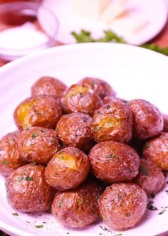 a white plate topped with meatballs covered in seasoning