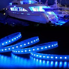 blue led strip lights in front of a boat at night