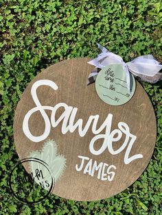 a wooden sign that says savyor james on it with a bow around the top