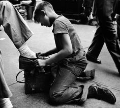 a man sitting on the ground working on something