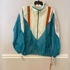 Vintage Nwt Reebok Men’s Blue & Cream Reebok Spell Out On One Arm/ Windbreaker Jacket. Zip Up/ Vent Back/ Zipper Pockets/ Rolled Hat With Snap Button Behind The Collar/ Size Xl See Measurements In Pictures. Only Little Flaw I See Small Blemish On Sleeve Part See Last Photo. 80’s 90’s Retro Track Jacket For Spring Sports, 90s Style Track Jacket For Spring Outdoor, Retro Spring Track Jacket For Sports, Retro Spring Track Jacket For Outdoor, 90s Style Spring Outdoor Track Jacket, Retro Blue Windbreaker For College, Blue Retro Windbreaker For Streetwear, Cream Reebok, Retro Blue Long Sleeve Windbreaker