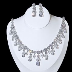 A luxurious two-piece bridal jewelry that will add elegance and sophistication to any wedding gown or formal ensemble! Adorned with intricately faceted cubic zirconia that capture the light from every angle with a perfectly translucent appeal, the pieces are platinum plated for a flawless finish which enhances the intricate detailing and conveys a modern take on old elegance. Necklace: 42cm (approx. 16.5") long with a secure fold-over closure (a 2" extension chain can be added upon request, plea Crystal Bridal Sets With Diamond Accents For Wedding, Cubic Zirconia Bridal Set With Sparkling Stones For Wedding, Dazzling Cubic Zirconia Bridal Sets For Wedding, Hand Set Crystal Bridal Sets For Wedding, White Crystal Bridal Sets With Sparkling Stones, Hand-set Cubic Zirconia Bridal Sets For Wedding, Hand Set Cubic Zirconia Bridal Sets For Wedding, Glamorous Diamond Accented Jewelry For Wedding, Glamorous Wedding Jewelry With Diamond Accents