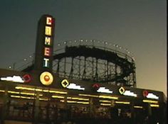 an amusement park lit up at night with the lights on and sign saying, emmet