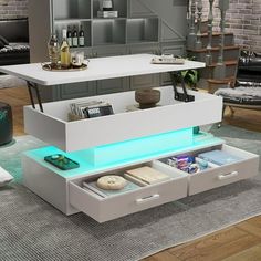 a modern coffee table with drawers and lights in the bottom drawer is lit up by blue light