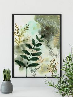 a painting hanging on the wall next to a potted plant