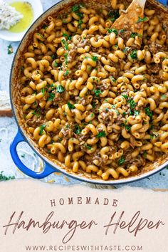 homemade hamburger helper pasta in a blue skillet with a wooden spoon on the side