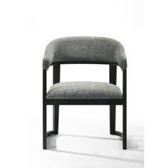 a gray chair sitting on top of a white floor next to a black wooden frame