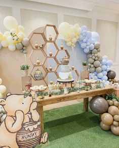 a winnie the pooh themed birthday party with balloons and desserts on a table