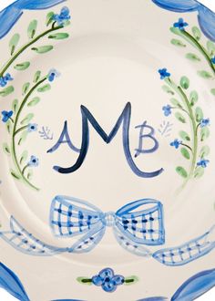 a blue and white plate with a bow tie on it's side that says, amb