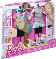 two barbie dolls standing next to each other in front of a display case with clothes and accessories