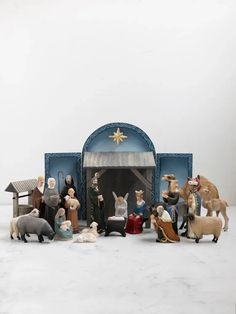 a nativity scene with figurines and animals