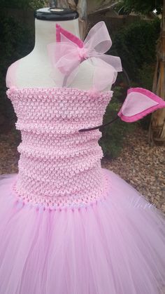 a dress made out of pink tulle and bows