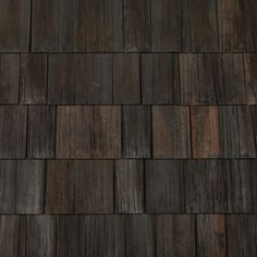 a close up view of a wooden roof with dark wood shingles on the side