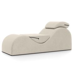 a white lounge chair with pillows on it