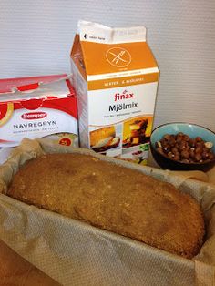 bread, milk and nuts are sitting on a table next to boxes of cereals