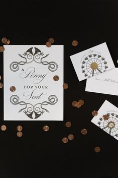 some cards and coins on a table with confetti scattered around them, including one that says penny for your seat