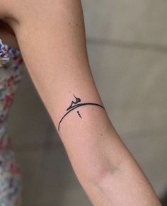 a woman's arm with a small tattoo on the left side of her arm