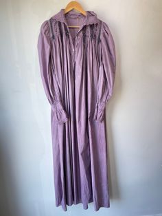 Vintage Victorian Overdyed Purple Dress. Lace-trimmed dress with bow details and puffy sleeves that make you feel like you're in a haunted 1920s mansion. The collar has black details that bring out the lacey designs. In good vintage condition with a few missing buttons (sold as is). Fits like a S/M. Feels like cotton/linen. Approx. Measurements: Underarm to underarm: 18" Length: 55" Vintage Dresses For Spring Night, Vintage Night Dresses For Spring, Long Sleeve Lace Trim Dress For Night, Long Sleeve Dresses With Lace Trim For Night, Long Sleeve Victorian Dress For Daywear, Peasant Style Victorian Dress For Daywear, Victorian Style Long Sleeve Prairie Dress For Daywear, Long Sleeve Vintage Dress With Lace Trim For Daywear, Victorian Prairie Dress With Long Sleeves For Daywear