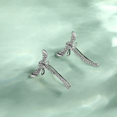 These sterling silver dragonfly earrings are symbolic of a lighter and brighter outlook on life - reminding us to live life to the fullest. This piece is undeniably shimmering and powerfully eye-catching - a dragonfly weaving through an earlobe is rarely seen! They make a delicate and meaningful gift for a loved one. Love life with our cute dragonfly climber earrings!Carat Weight: 0.748 ctStone Size: 1,1.2,1.3 mmStone Type: Jeulia® StoneNumber of Stones: 64 Stone Shape: RoundStone Color: Diamond Elegant Sterling Silver Dragonfly Earrings, Elegant Dragonfly Earrings With Ear Wire, Silver Fine Jewelry Ear Climbers As Gift, Silver Ear Climbers Fine Jewelry Gift, Elegant Silver Ear Climbers As Gift, Elegant Silver Ear Climbers For Gifts, Elegant Dragonfly Jewelry With Ear Wire, Cute Dragonfly, Live Life To The Fullest