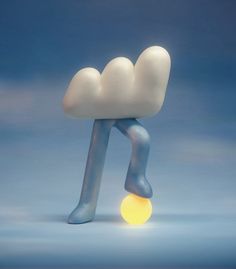 a cloud shaped object with a yellow ball in front of it on a blue background