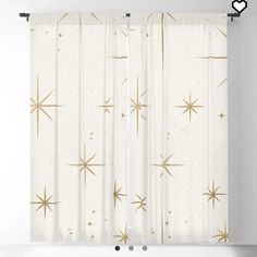 a white curtain with gold stars on it