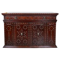 an old wooden chest with metal rivets on the front and sides, isolated against a white background