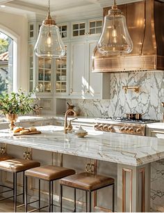 a kitchen with marble counter tops and stools in front of an island that has gold accents