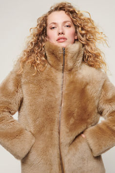 Make a statement in the fabulously stylish, wonderfully warm, and timelessly luxurious Adriana jacket. Luxury Mink-colored Outerwear For Cold Weather, Luxury Mink Outerwear For Cold Weather, Luxury Mink Outerwear With Faux Fur Trim, Luxury Mink Outerwear With Faux Fur Lining, Shearling Outerwear In Mink For Cold Weather, Sheepskin Outerwear In Mink Color For Cold Weather, Sheepskin Mink-colored Outerwear For Cold Weather, Fall Sheepskin Outerwear In Mink Color, Luxury Sheepskin Outerwear In Mink Color