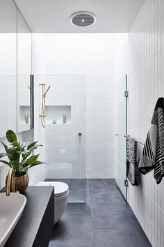 a white bathroom with black and white tiles on the floor, walls and ceiling is featured in an article titled today's ideas wood wall art