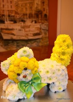 a teddy bear made out of flowers sitting on top of a table