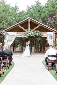 a bride and groom standing at the end of their wedding ceremony