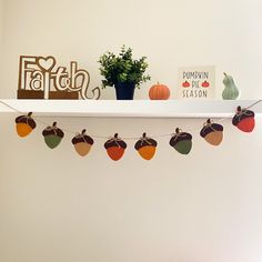 a white shelf with pumpkins and fall decorations on it